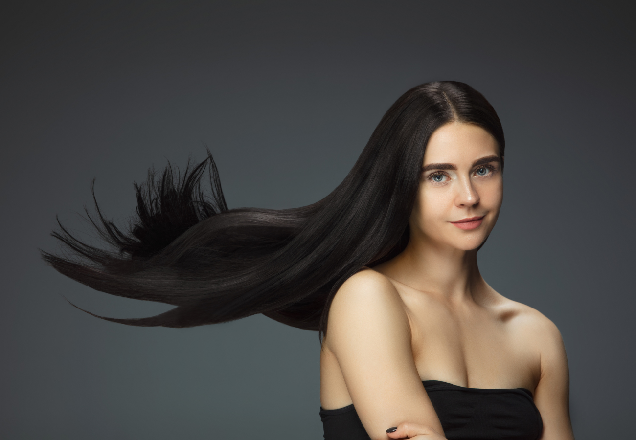 Image of a woman with long black hair on Eldorado Hair Restoration's website