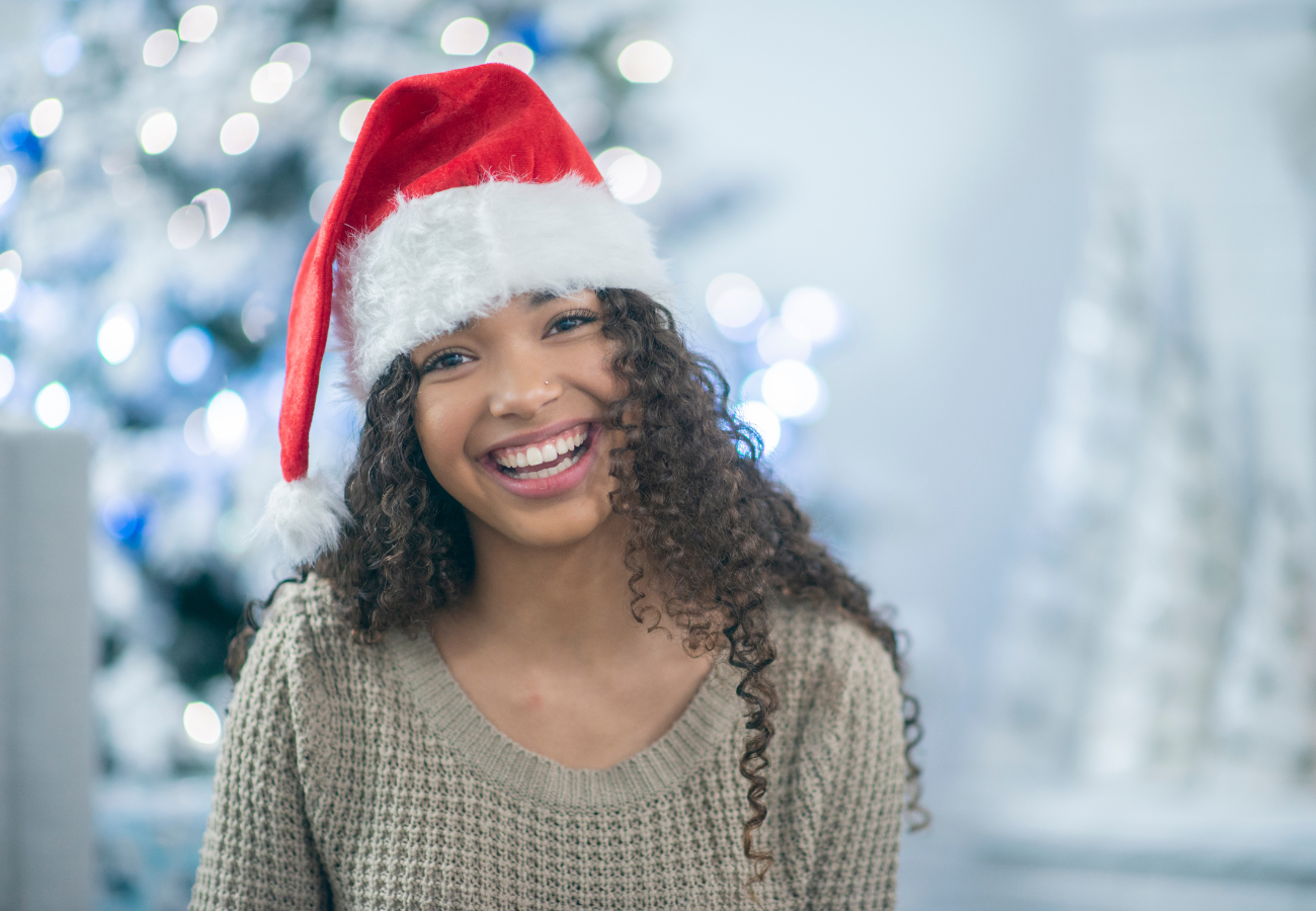 Image of a smiling woman wearing a Santa hat on Eldorado's website