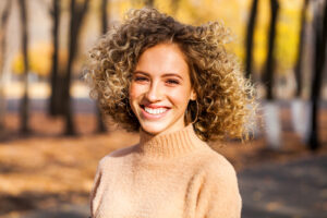 Woman with curly hair outside