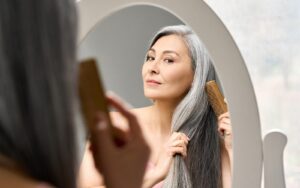 Image of a woman with gray hair on Eldorado Hair Restoration's website.