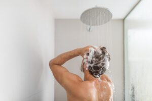 Image of a man washing his hair in the shower