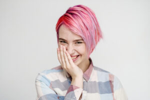 Image of a girl with a short pink textured haircut