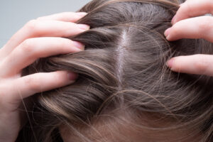 Image of a woman parting her hair