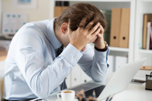 A stressed out man sitting at a desk